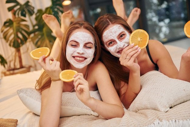 white clearing mask faces two happy women is bachelorette party together_146671 61923